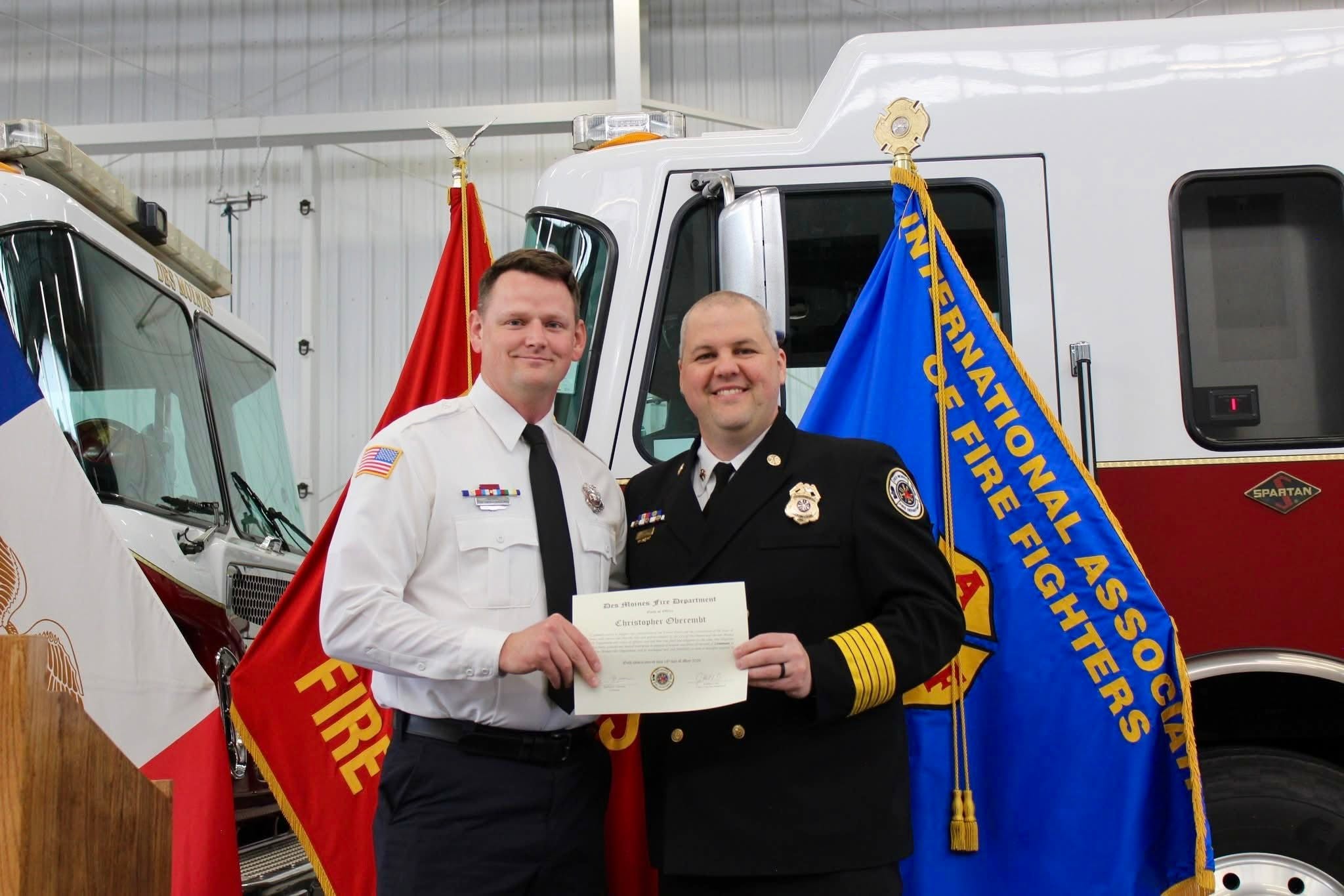 Christopher Oberembt, at left, during a Des Moines Fire Department promotion ceremony